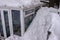 Snow piled up high at side of conservatory.