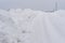 Snow Piles Along Slippery Rural Road