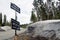 snow piles on road side with traffic signs in Sierra Nevada mountains
