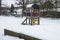 Snow on the playground equipment of a schoolyard