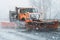 Snow plough truck vehicle ploughing streets highway during nor easter in new england connecticut
