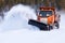 Snow plow clearing road after winter snow storm