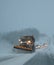 Snow plow scraping snow off a busy Ontario road with trail of cars behind