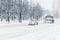 Snow plow truck convoy with patrol police car