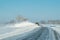 Snow removal equipment, truck, winter clears snow from the icy country road