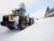 Snow removal with heavy loader machinery after stormy winter blizzard