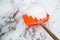 Snow removal. Orange Shovel in snow.