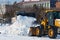 Snow removal from the road. Two tractor graders remove snow from a street in Blagoveshchensk, Russia. Work of public services.