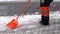 Snow removal from the sidewalk after a snowstorm.A road worker clears the sidewalk of snow