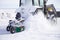 Snow removal vehicle close up. Snow plow tractor is cleaning a city after snowstorm