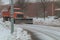 Snow remover truck cleaning city streets in snow storm