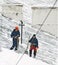 Snow removers standing on snowed rooftop