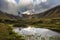 Snow, rocks and river in Collanes Valley in El Altar volcano