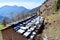 Snow on Roof of a Hut in a Village with Himalayan Mountains in Background - Winter in Himalayas, Uttarakhand, India