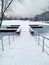 Snow stairs with iced winter river and trees