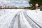 Snow tracks on a country road.