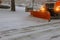 Snow tractor removes snow during snowfall