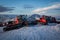 Snow tractors in the rays of sunset on the slopes of Mount Elbrus