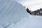 Snow wall on the roadside in an alpine scenery