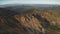 Snow way at mountain top aerial. Nobody nature landscape. Brown burnt grass, fir forest mount hill