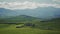 Snow-white clouds quickly float over the picturesque landscape of Tuscany. Panorama