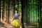 Snow White cosplay in the mysterious forest closeup. Artistic processing