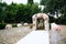 The snow-white path that leads to the altar. Wedding decorations, a wedding arch decorated with peonies, bouquets of