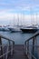 Snow-white yachts against the backdrop of a beautiful sunset sky in the port of the Spanish city of Valencia.