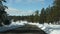 Snow in wintry forest, driving auto, road trip in winter Utah USA. Coniferous pine trees, view from car thru windshield