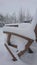 Snow on a wooden garden chair