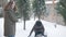 Snowball fight of two joyful young Caucasian women outdoors. Happy cheerful positive friends having fun outdoors on