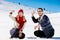 Snowball fight. Winter couple having fun playing in snow outdoors. Young joyful happy multi-racial couple.