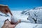 Snowball with two hands on blurred beautiful view of Aletsch Glacier in Jungfraujoch background