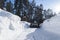 Snowblower at work on a winter day. Snowplow removing snow after blizzard. Clearing the ice. Snow removal machine. Clear driveway