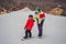 Snowboard instructor teaches a boy to snowboarding. Activities for children in winter. Children`s winter sport