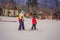 Snowboard instructor teaches a boy to snowboarding. Activities for children in winter. Children`s winter sport