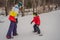 Snowboard instructor teaches a boy to snowboarding. Activities for children in winter. Children`s winter sport