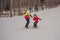 Snowboard instructor teaches a boy to snowboarding. Activities for children in winter. Children`s winter sport