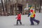 Snowboard instructor teaches a boy to snowboarding. Activities for children in winter. Children`s winter sport