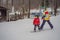 Snowboard instructor teaches a boy to snowboarding. Activities for children in winter. Children`s winter sport