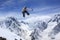 Snowboard rider jumping on mountains. Extreme snowboard freeride sport.