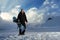 Snowboarder in black suit standing on the road