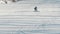 Snowboarder carves down the hill and performs buttering tail grab trick