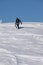 Snowboarder climbing a snowy mountain