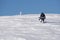 Snowboarder climbing a snowy mountain