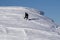 Snowboarder climbing a snowy mountain