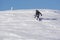 Snowboarder climbing a snowy mountain