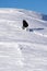 Snowboarder climbing a snowy mountain