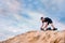 Snowboarder climbs to top of sand dune for snowboarding