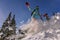 Snowboarder doing a toe side carve with deep blue sky in background